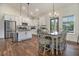 Open-concept kitchen boasts white cabinets, stainless steel appliances, granite countertops, and adjacent dining area at 461 Barnwood Dr, Rockmart, GA 30153