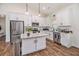 Modern kitchen featuring white cabinets, granite countertops, stainless steel appliances, and a functional center island at 461 Barnwood Dr, Rockmart, GA 30153