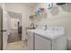 Bright laundry room with washer, dryer, and overhead shelving at 461 Barnwood Dr, Rockmart, GA 30153