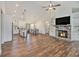 Open-concept living space with fireplace, modern kitchen, dining area, wood flooring, and natural light at 461 Barnwood Dr, Rockmart, GA 30153