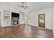 Inviting living room with a stone fireplace, vaulted ceiling, wood floors, and natural light at 461 Barnwood Dr, Rockmart, GA 30153