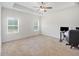 Spacious main bedroom featuring a ceiling fan, carpet flooring, and natural light from two windows at 461 Barnwood Dr, Rockmart, GA 30153