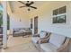 Covered patio area furnished with stylish wicker seating and a ceiling fan for outdoor relaxation at 461 Barnwood Dr, Rockmart, GA 30153