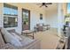 Covered patio with comfortable wicker furniture, ceiling fan, and door access to interior of the home at 461 Barnwood Dr, Rockmart, GA 30153