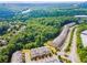 A beautiful aerial view of a townhome community nestled among trees near a river and office buildings at 502 Abbington River Ln, Atlanta, GA 30339