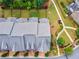 Aerial view of townhomes with manicured green spaces and sidewalk network, community spaces and parking at 502 Abbington River Ln, Atlanta, GA 30339