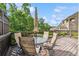 Back deck with wooded views and featuring a glass table and comfortable seating for entertaining at 502 Abbington River Ln, Atlanta, GA 30339