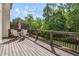 Private back deck featuring railing and outdoor seating overlooking a lush green space at 502 Abbington River Ln, Atlanta, GA 30339