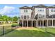 Spacious backyard with a covered patio and well-maintained lawn surrounded by black metal fencing at 502 Abbington River Ln, Atlanta, GA 30339