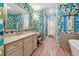 Unique bathroom boasting floral wallpaper, double sinks and a freestanding tub at 502 Abbington River Ln, Atlanta, GA 30339