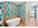 Bathroom featuring stylish wallpaper, modern fixtures, and a soaking tub at 502 Abbington River Ln, Atlanta, GA 30339