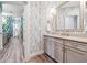 Stylized bathroom featuring a vanity area and a patterned wall at 502 Abbington River Ln, Atlanta, GA 30339