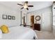 Bedroom with neutral walls, white carpet, ceiling fan, and an ensuite bathroom at 502 Abbington River Ln, Atlanta, GA 30339