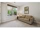 Cozy bedroom provides a comfortable seating area and a large window with outdoor views at 502 Abbington River Ln, Atlanta, GA 30339