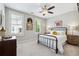 Cozy bedroom featuring a black metal bed frame, neutral walls, and white carpet at 502 Abbington River Ln, Atlanta, GA 30339