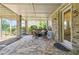 Covered patio with brick columns, stone floors and comfortable wicker seating arrangement at 502 Abbington River Ln, Atlanta, GA 30339