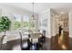 Cozy dining area with modern light fixture, plantation shutters, and views to the front at 502 Abbington River Ln, Atlanta, GA 30339