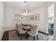 Dining room with modern lighting, neutral colors, and wainscoting at 502 Abbington River Ln, Atlanta, GA 30339