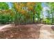A fenced dog park area with a gate, walking path, and shade trees for outdoor enjoyment at 502 Abbington River Ln, Atlanta, GA 30339