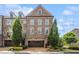 Beautiful brick townhome with manicured landscaping and attached garage at 502 Abbington River Ln, Atlanta, GA 30339