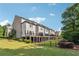 View of the townhouse complex from the backyard, featuring decks and manicured lawns at 502 Abbington River Ln, Atlanta, GA 30339