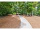 Charming outdoor fire pit area and benches accessible via a paved path, for socializing at 502 Abbington River Ln, Atlanta, GA 30339