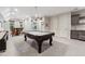 Entertaining game room features a pool table, shuffleboard, wet bar, and a table with seating at 502 Abbington River Ln, Atlanta, GA 30339