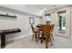 Game room with a table, seating, shuffleboard, and views of the outdoor patio through glass doors at 502 Abbington River Ln, Atlanta, GA 30339