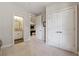 Hallway featuring doorways to a bathroom and a game room, adding functionality and charm at 502 Abbington River Ln, Atlanta, GA 30339