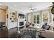 Bright living room with fireplace, built-ins, and access to outdoor space at 502 Abbington River Ln, Atlanta, GA 30339