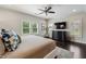 Light filled main bedroom with dark wood floors, large windows and a ceiling fan at 502 Abbington River Ln, Atlanta, GA 30339