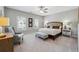 Spacious main bedroom featuring neutral tones, soft carpet, a king bed, and large windows at 502 Abbington River Ln, Atlanta, GA 30339