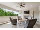 Covered patio featuring comfortable seating, a fireplace, a mounted tv, and scenic outdoor views at 502 Abbington River Ln, Atlanta, GA 30339