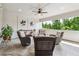 Relaxing outdoor patio with comfortable seating, ceiling fan, and picturesque views of lush greenery at 502 Abbington River Ln, Atlanta, GA 30339