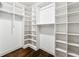 Large walk-in closet with custom shelving and ample storage space at 502 Abbington River Ln, Atlanta, GA 30339
