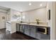 Stylish wet bar features gray cabinets, granite countertops, stainless steel appliances, and accent decor at 502 Abbington River Ln, Atlanta, GA 30339