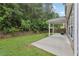 Landscaped backyard with a stone retaining wall, a small lawn, and a covered patio at 5937 Sharp Se Dr, Mableton, GA 30126