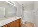 Bright bathroom features a large mirror, wood vanity, and a shower-tub combination at 5937 Sharp Se Dr, Mableton, GA 30126