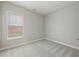 Empty bedroom with neutral carpet, grey walls and a window letting in natural light at 5937 Sharp Se Dr, Mableton, GA 30126