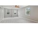 Empty bedroom with neutral carpet, grey walls, and a window letting in natural light at 5937 Sharp Se Dr, Mableton, GA 30126