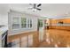 Spacious living room featuring hardwood floors, a ceiling fan, fireplace and natural light from plentiful windows at 5937 Sharp Se Dr, Mableton, GA 30126