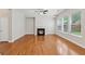 Bright living room with a modern fireplace, hardwood floors, natural light, and a ceiling fan at 5937 Sharp Se Dr, Mableton, GA 30126
