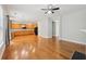 Open-concept living room featuring hardwood floors, a fireplace, ceiling fan, and an adjacent kitchen at 5937 Sharp Se Dr, Mableton, GA 30126
