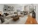 Bright living room features wood floors, neutral decor, stairway, and dining area with large window at 5937 Sharp Se Dr, Mableton, GA 30126