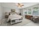 Stylishly furnished main bedroom with three large windows, decorative art and ceiling fan at 5937 Sharp Se Dr, Mableton, GA 30126