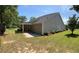 Large backyard featuring a covered patio, green grass, and new, gray siding at 964 Village View Cir, Loganville, GA 30052