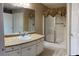 Well-lit bathroom with a shower, vanity, and double-door linen closet for added storage at 964 Village View Cir, Loganville, GA 30052