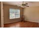 Comfortable bedroom with hardwood floors, a ceiling fan, and a bright window at 964 Village View Cir, Loganville, GA 30052