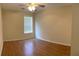 Bright bedroom featuring hardwood floors, a ceiling fan, and a window with natural light at 964 Village View Cir, Loganville, GA 30052