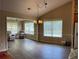 Bright dining area featuring wood floors, natural light, and elegant chandelier at 964 Village View Cir, Loganville, GA 30052
